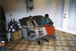 Photograph of Two Individuals Sitting at a Potluck/Party by Las Vegas Chapter of the National Bar Association